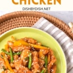 A plate of honey sesame chicken on a bamboo tray.