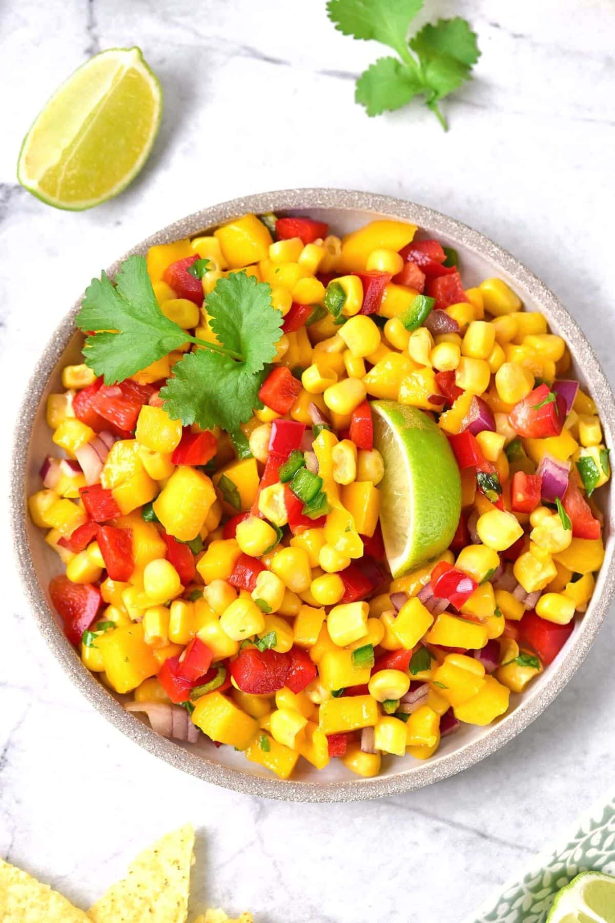 Top down view of a plate of mango and corn salsa.