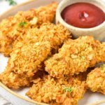 A plate of cornflake chicken strips.