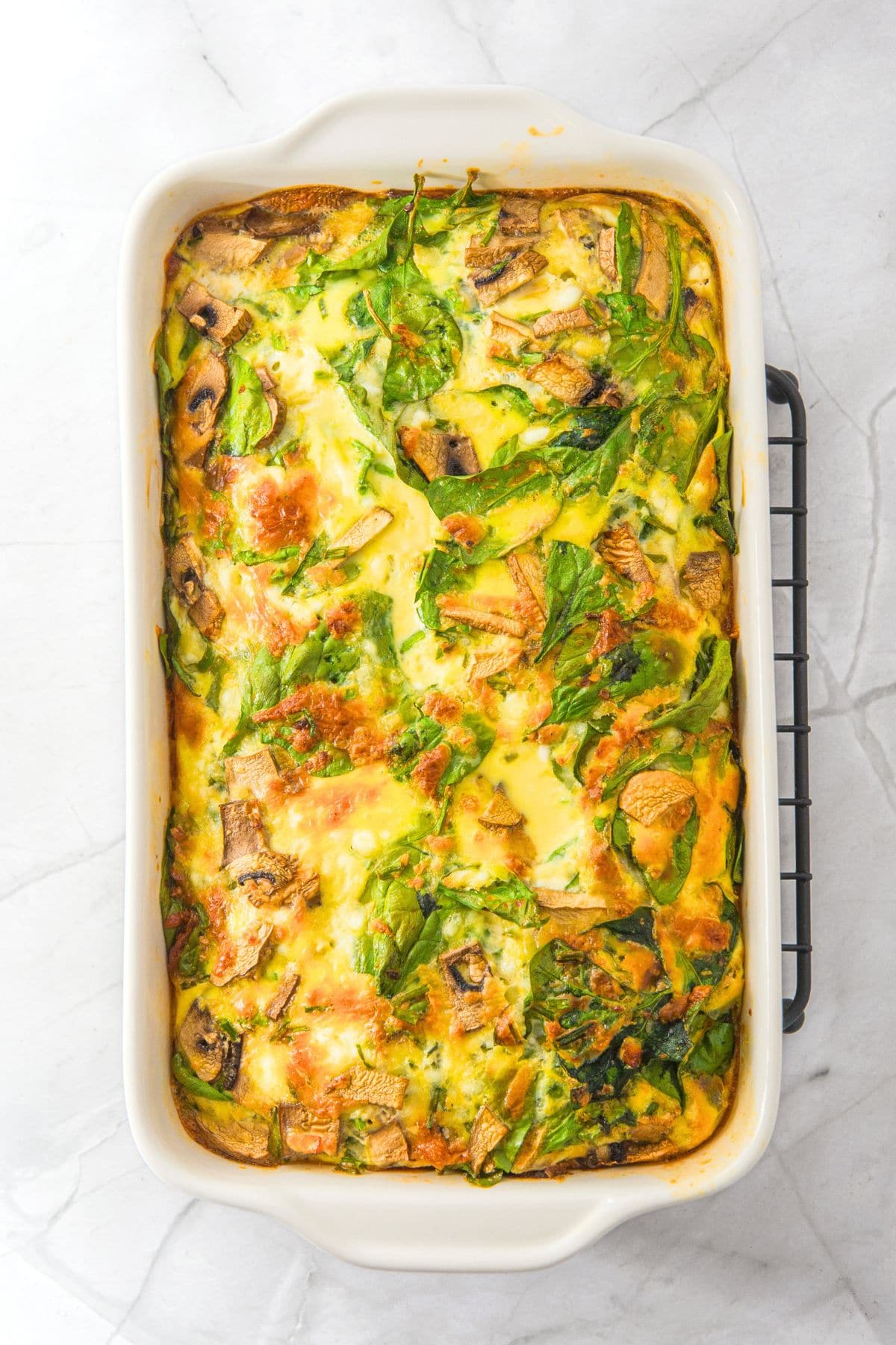Freshly baked cottage cheese egg bake on wire rack.