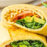 Up close view of half-sliced veggie wrap.