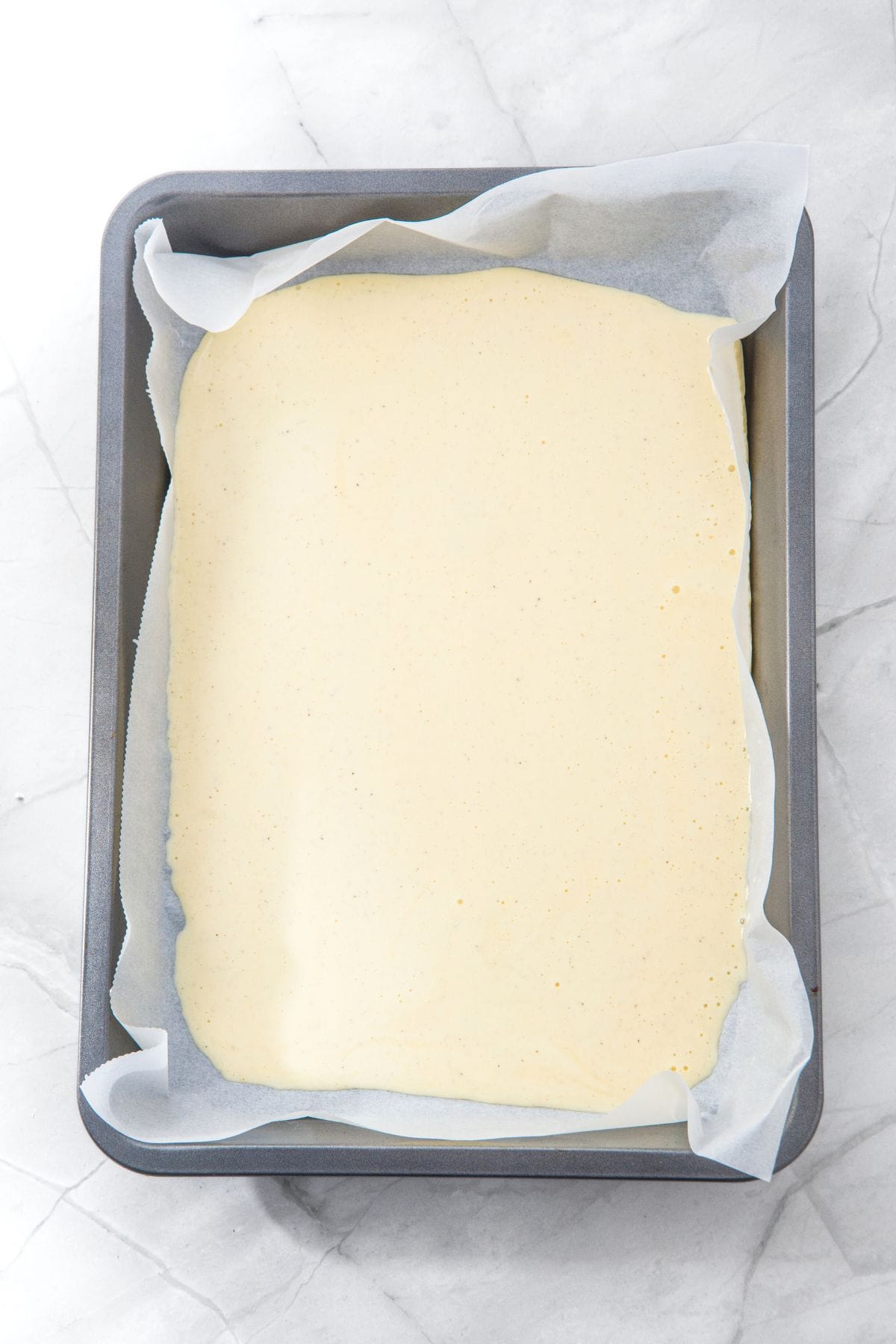 Cottage cheese batter in parchment-lined baking sheet