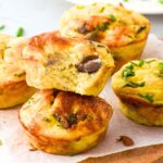 Half-eaten cottage cheese and egg muffins on board.
