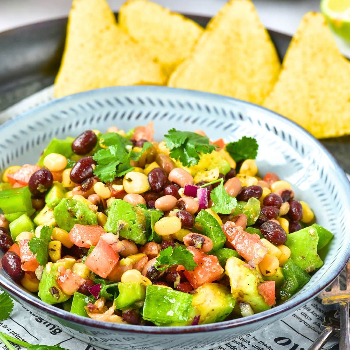A bowl of cowboy caviar with tortilla chips