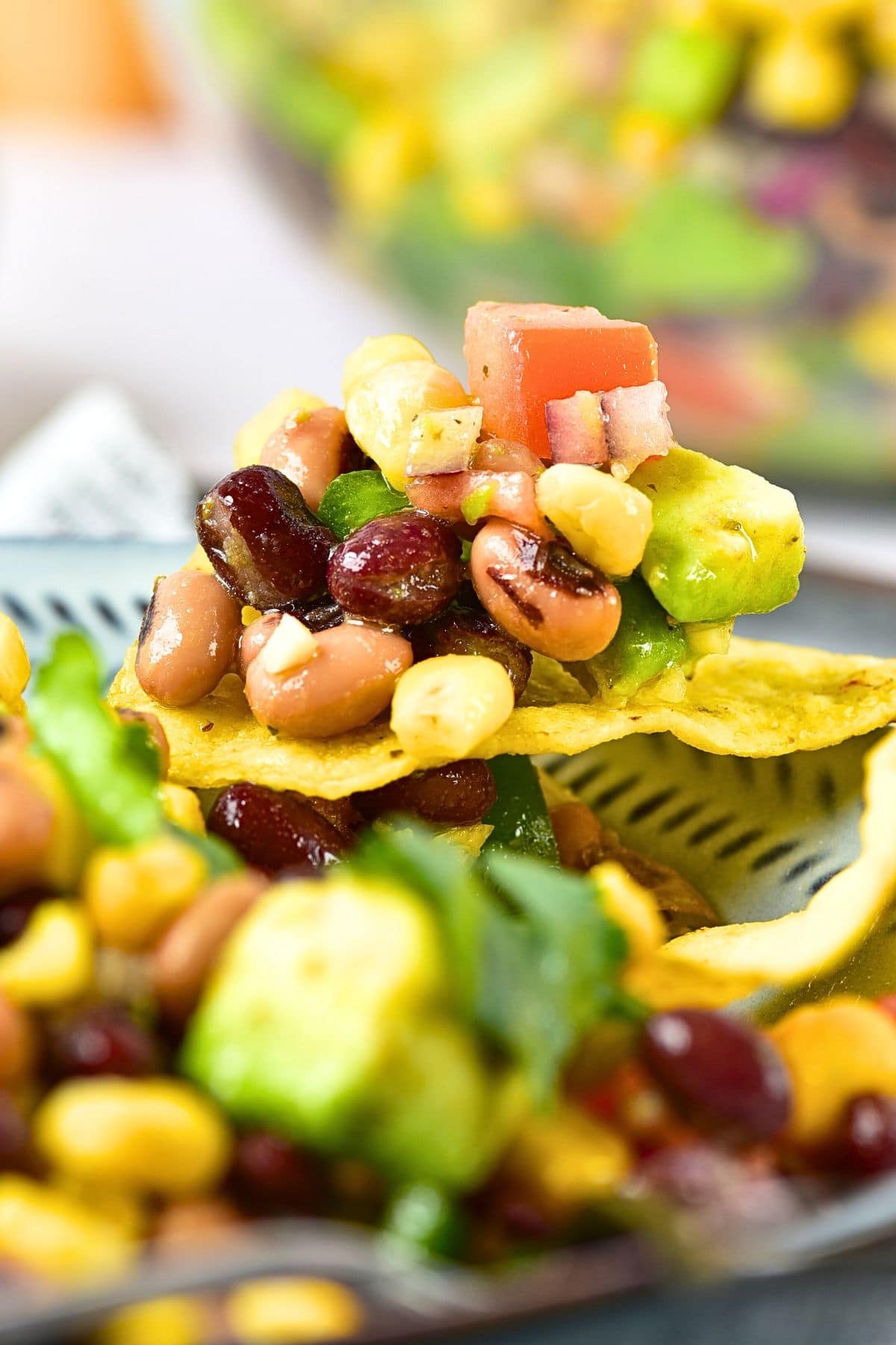 Using a tortilla chip to scoop up easy cowboy caviar