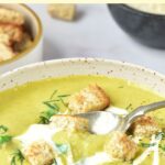 Scooping up a spoonful of asparagus and potato soup