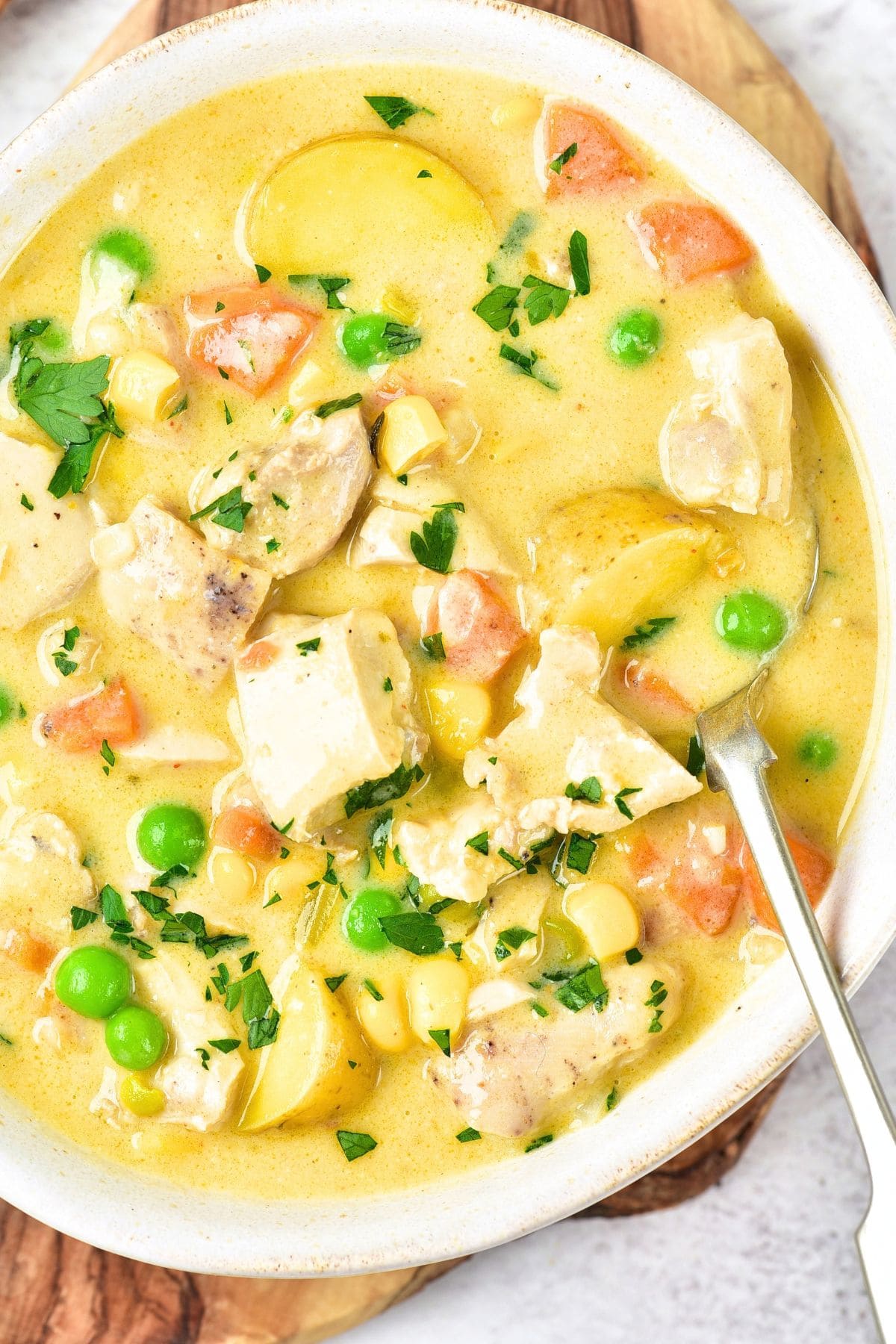 Up close view of a bowl of creamy chicken and potato soup.