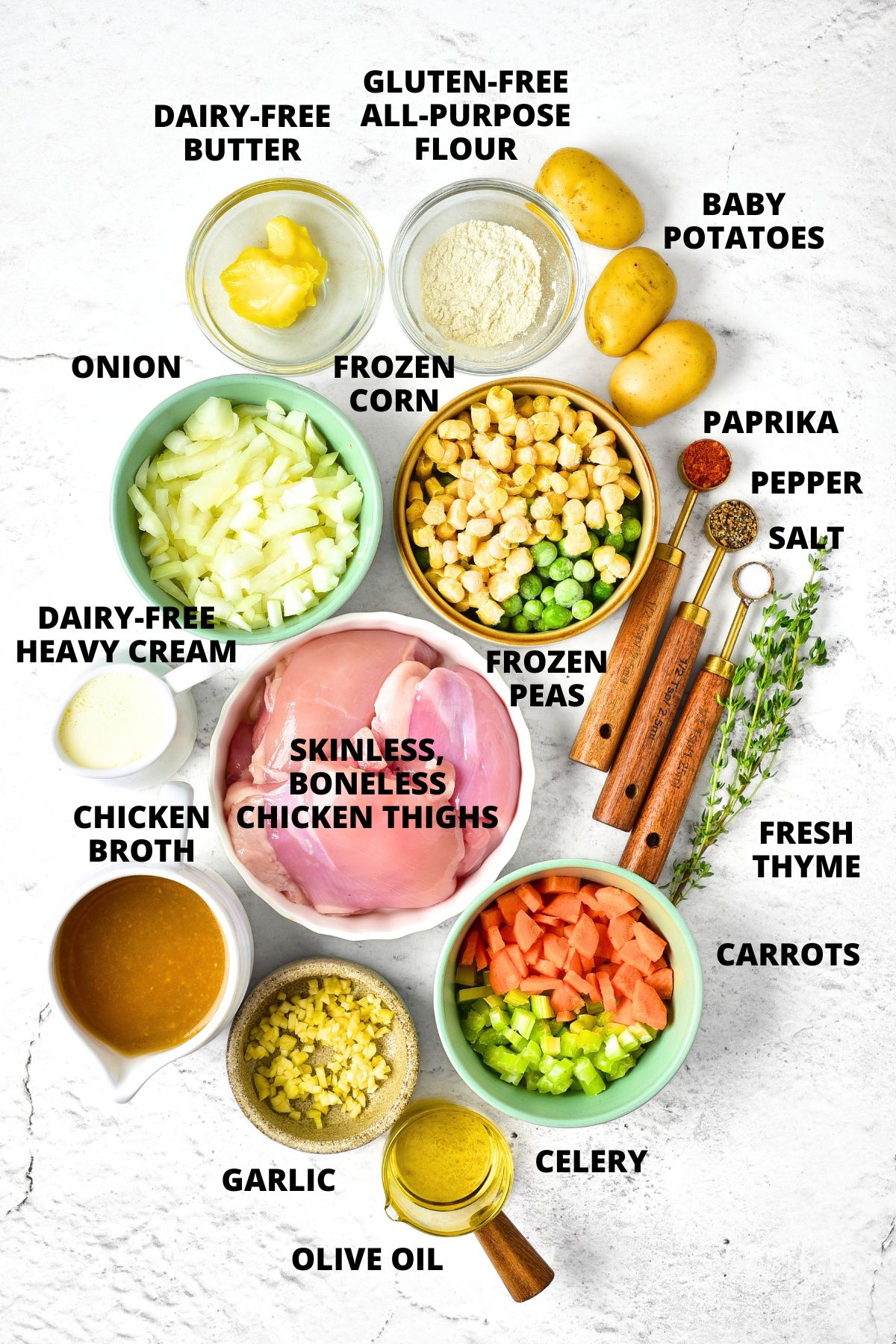 Ingredients for creamy chicken soup recipe laid out on marble board