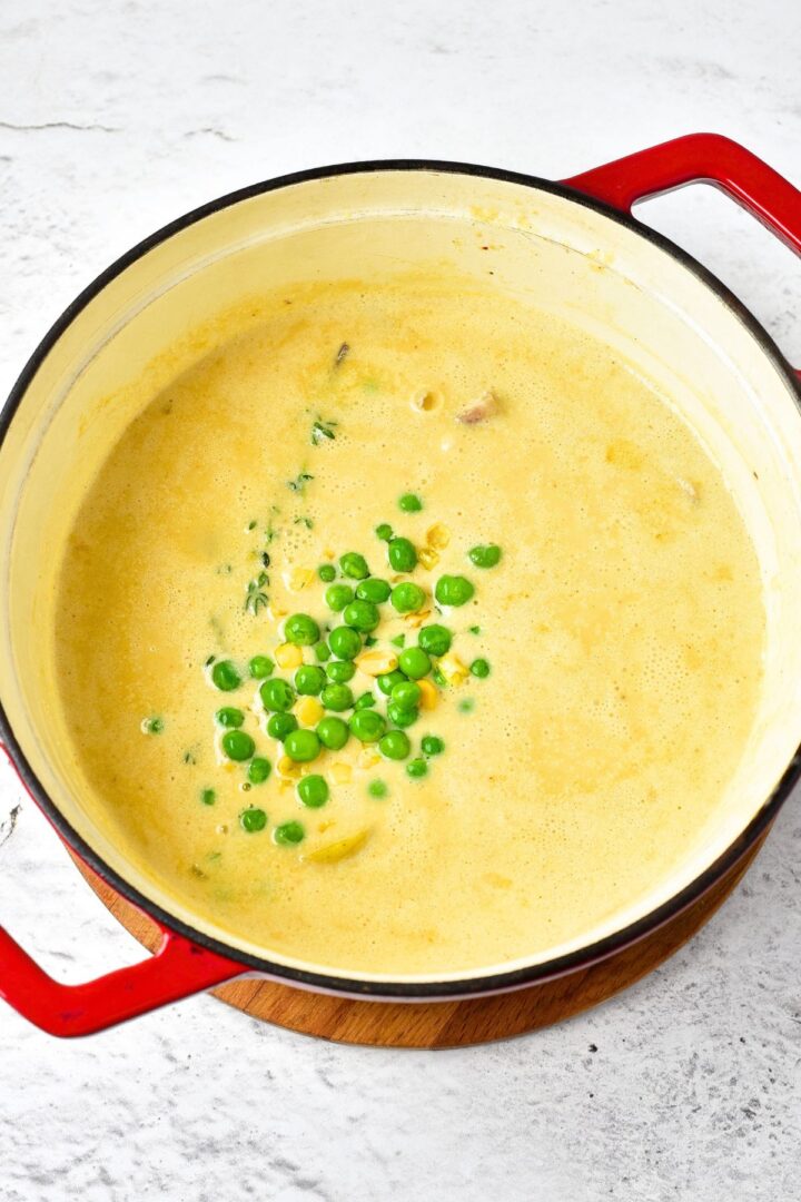 Fresh peas on top of creamy chicken soup.