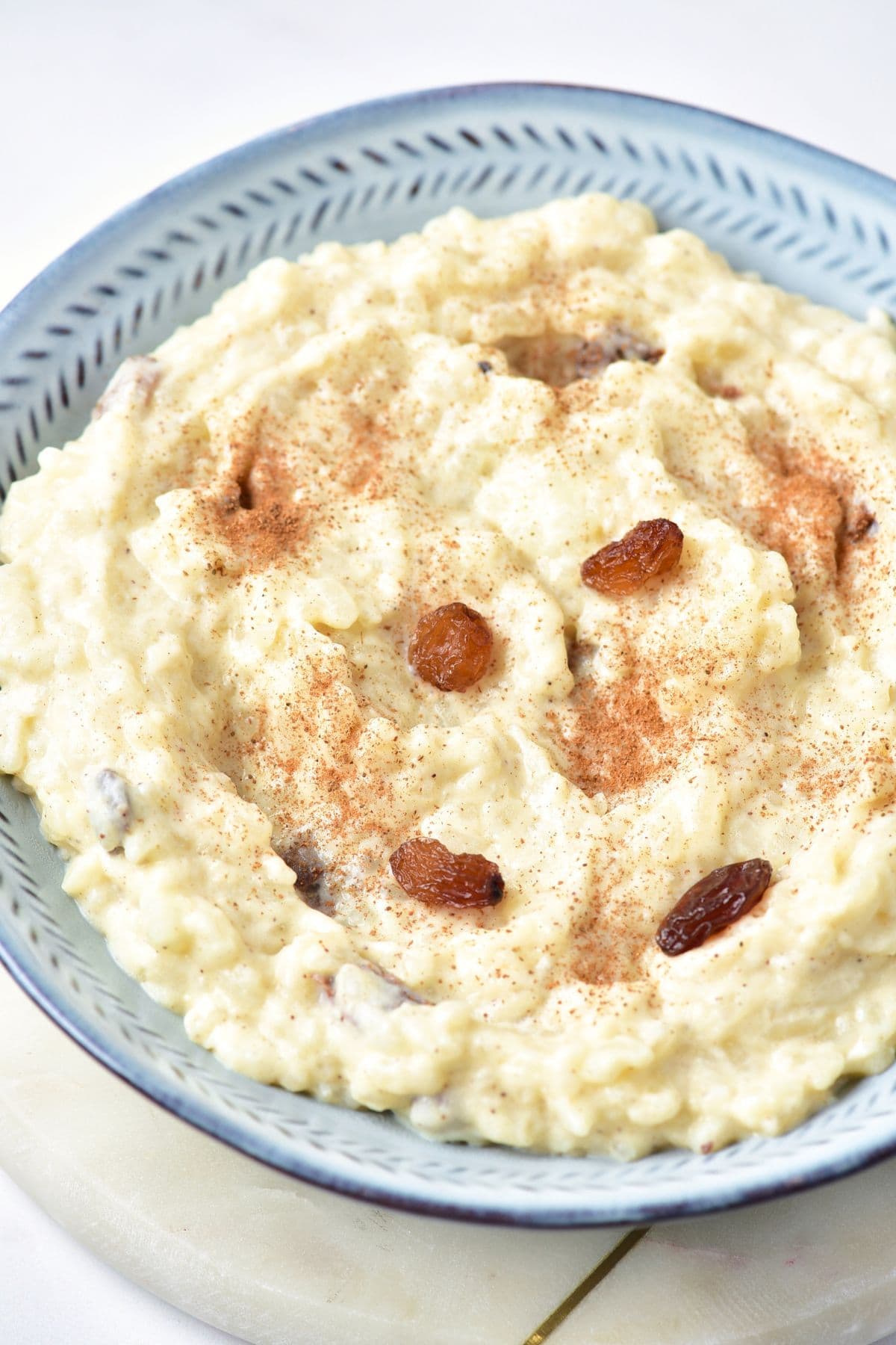 Up close view of raisins on top of rice pudding