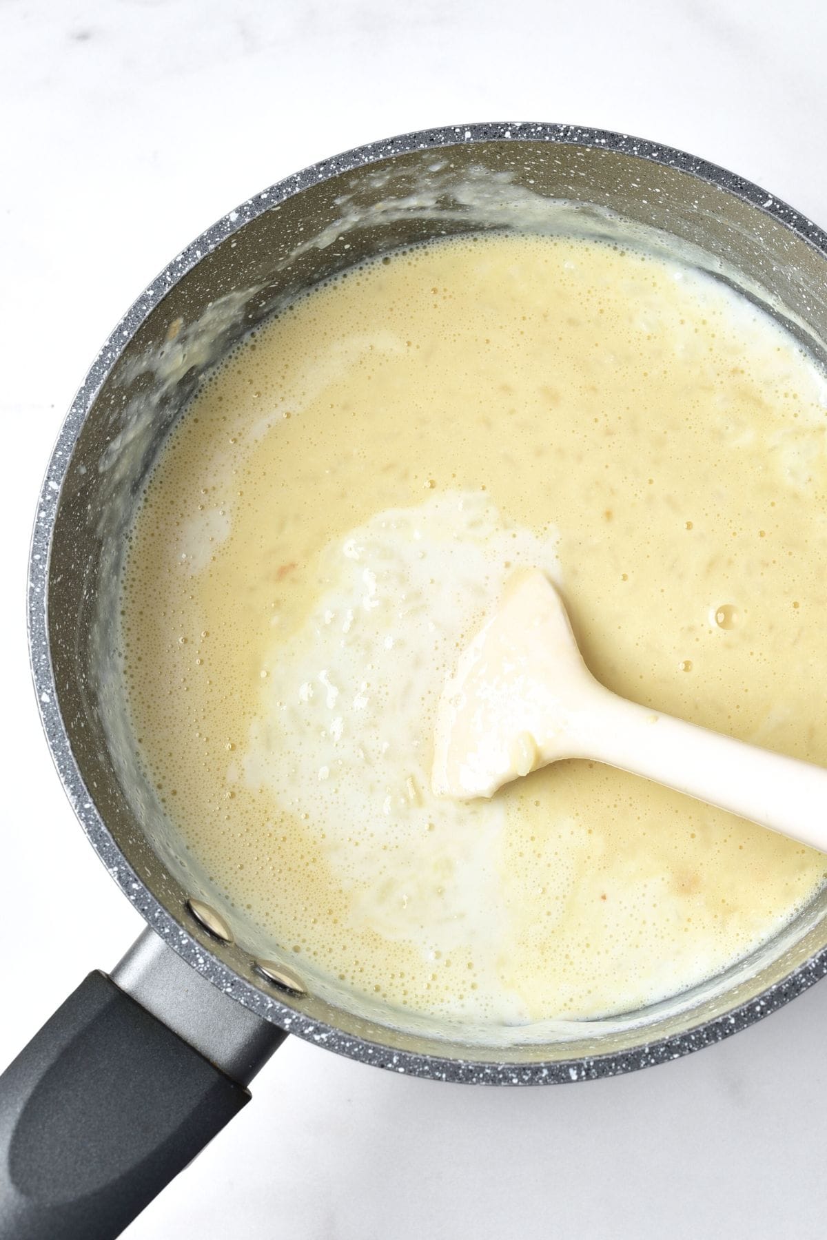 Mixing rice mixture in pot.
