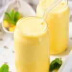 Mango milkshake garnished with mint leaves.