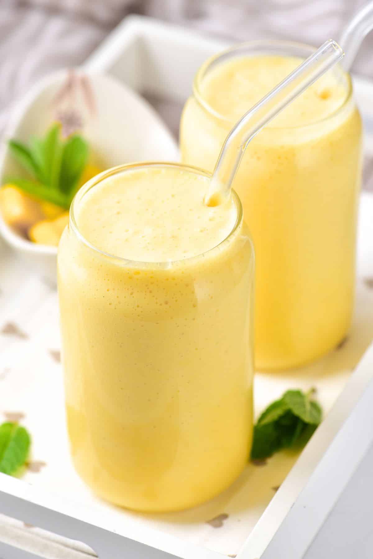 Glasses of creamy mango milkshake.