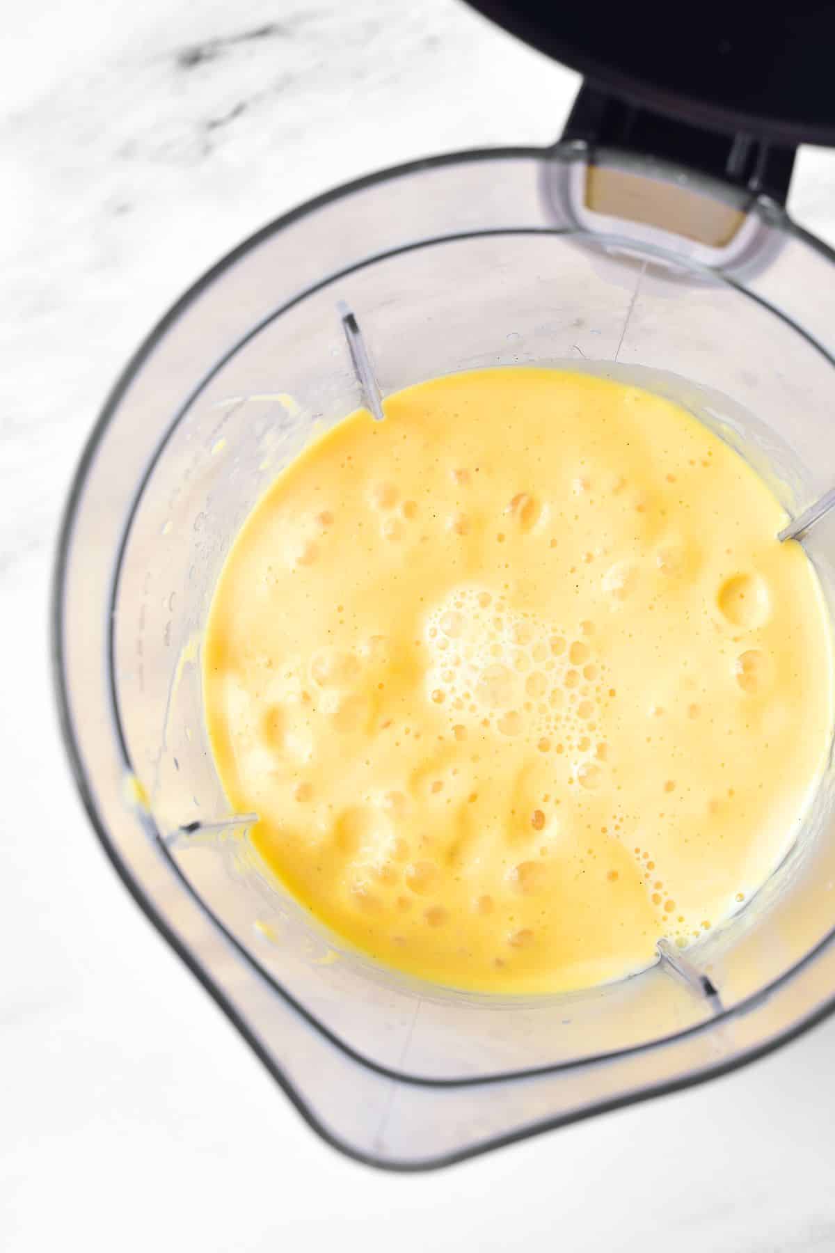 Blended mango shake in blender