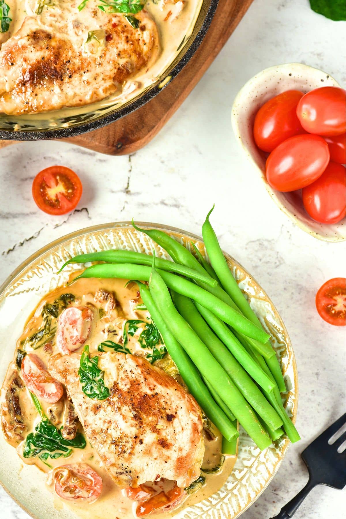 One Pan Tuscan Chicken (Gluten-Free, Dairy-Free) Top down view of Tuscan chicken and green beans on a plate