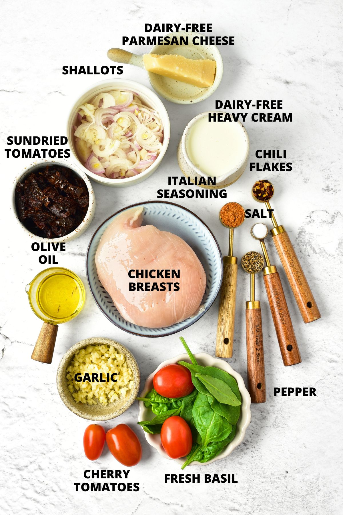 Creamy Tuscan Chicken (Gluten-Free, Dairy-Free) Ingredients for creamy tuscan chicken recipe laid out on marble board