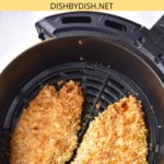 Air fried chicken cutlets in air fryer basket.