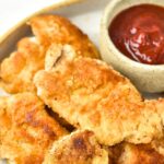 Crispy almond flour chicken on ketchup