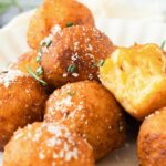 A plate of half-eaten potato balls.