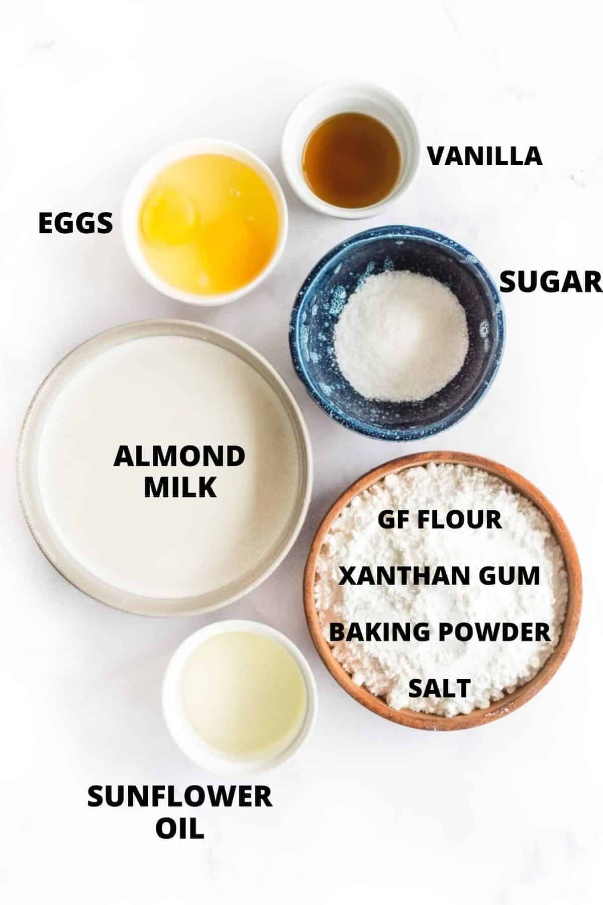 Ingredients for gluten-free waffles recipe laid out on white board.