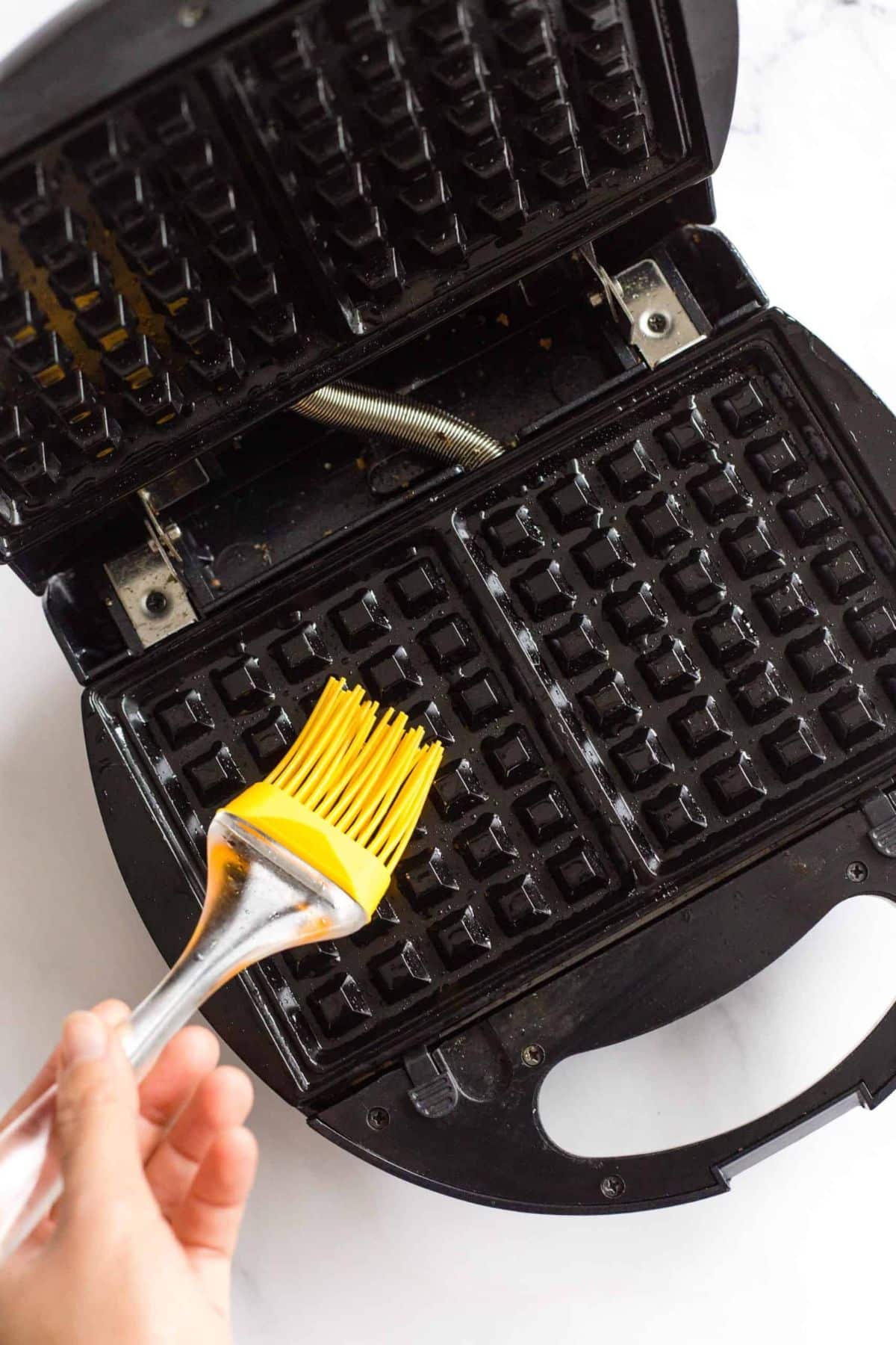 Brushing waffle iron with oil