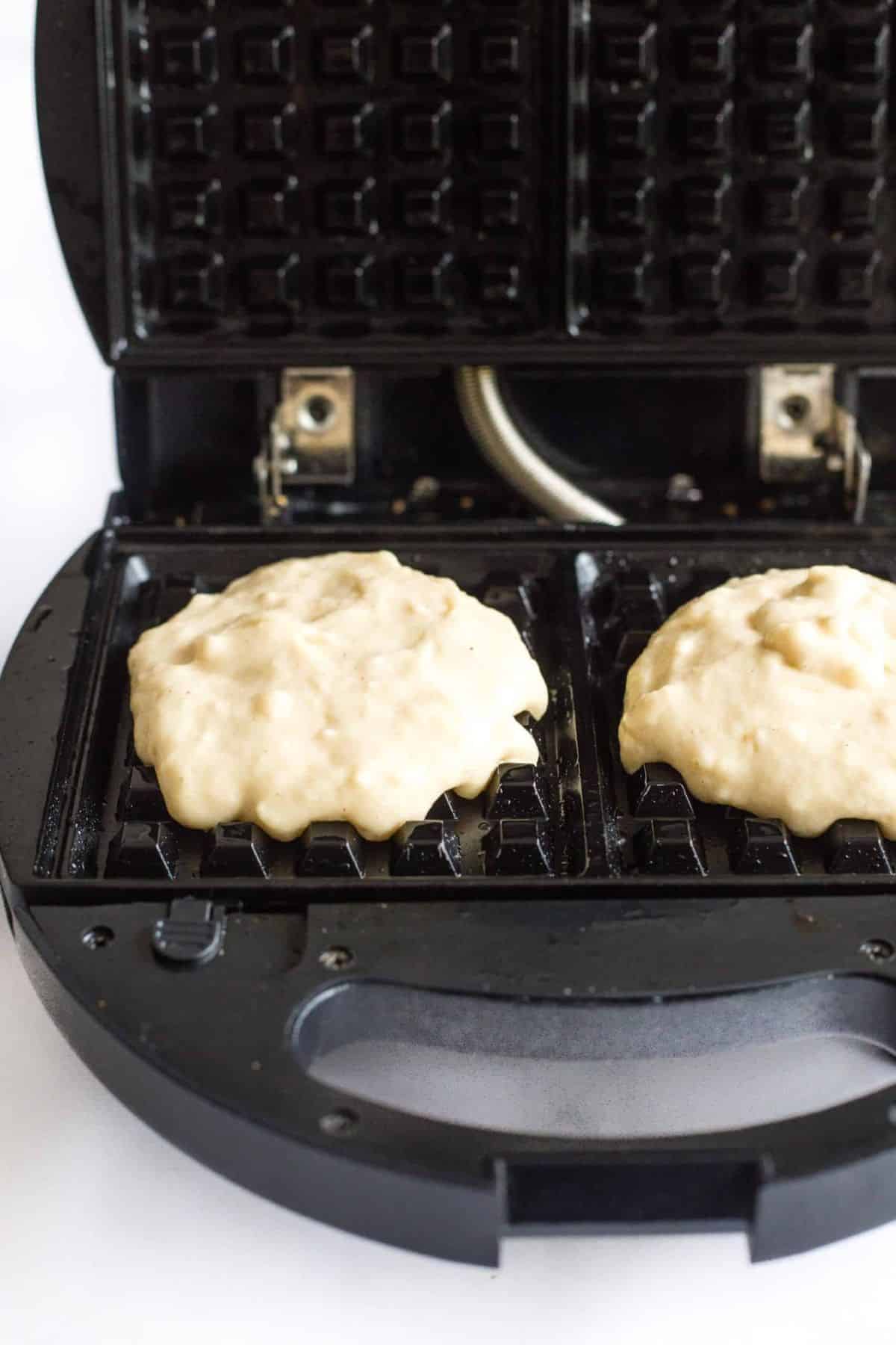 Waffle batter on waffle iron to be cooked.