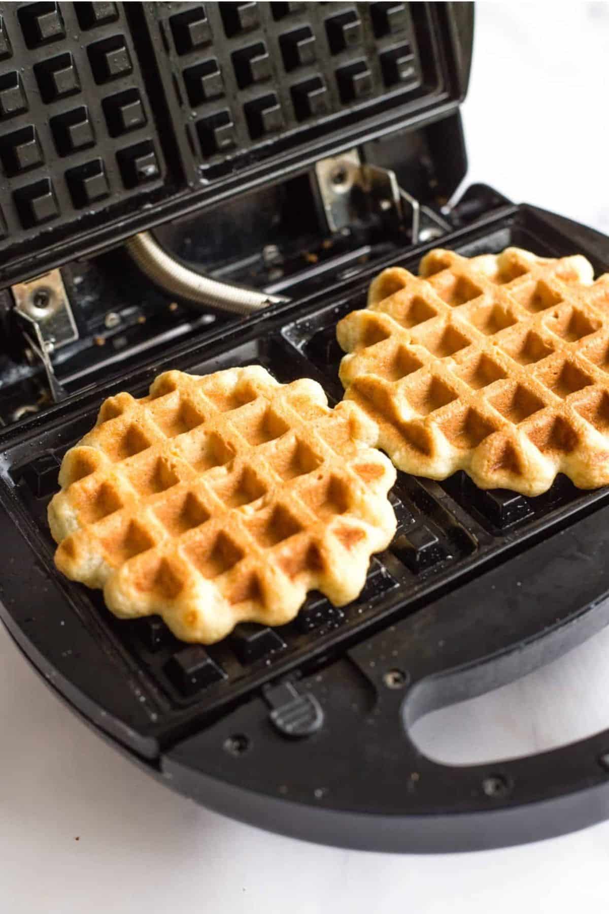 Freshly cooked waffles om waffle iron.