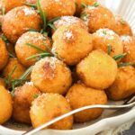 A plate of crispy fried potato balls