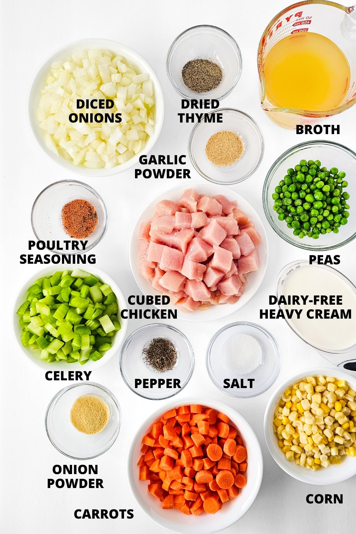 Ingredients for crustless chicken pot pie recipe laid out on white board.