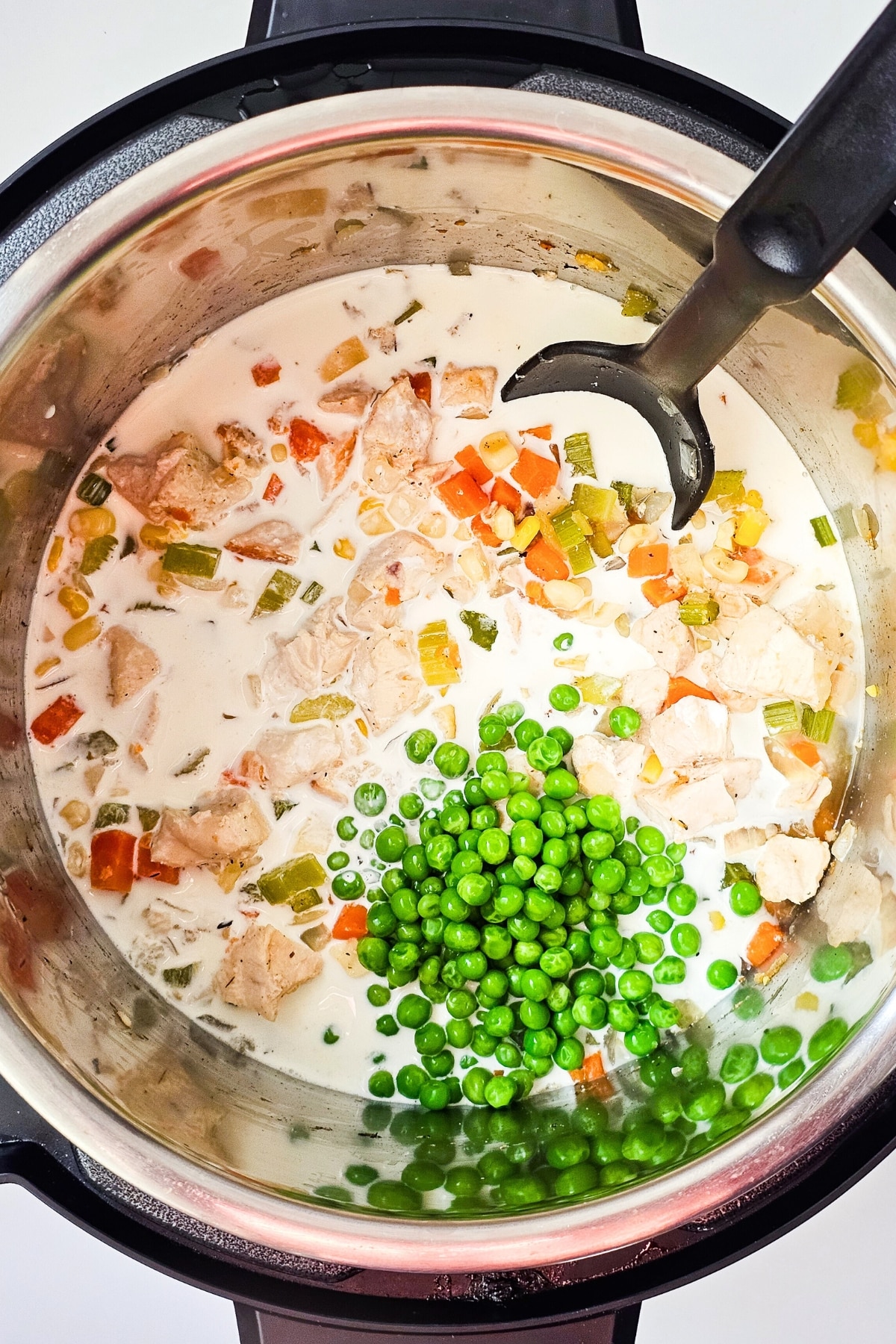 Peas on top of ingredients.