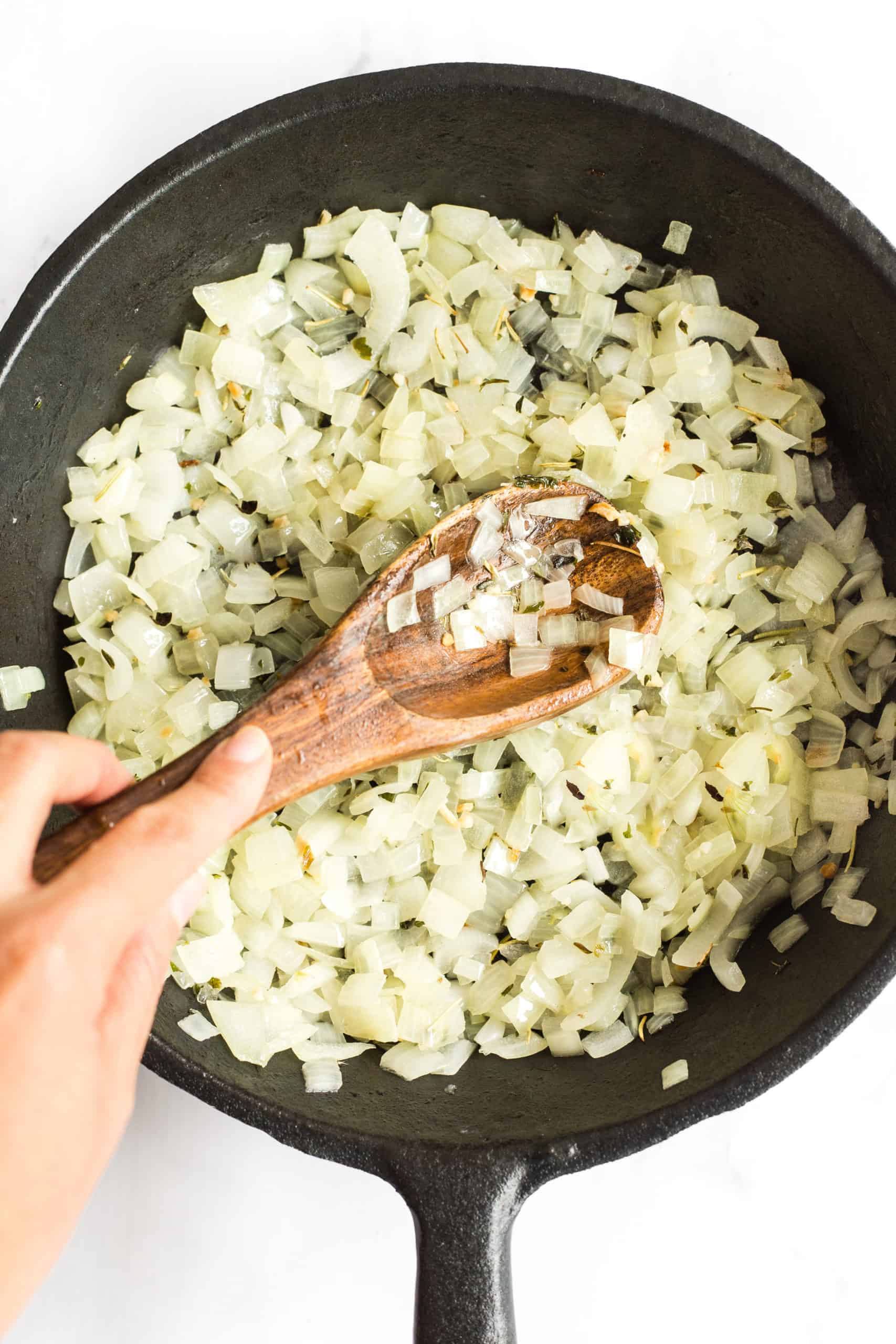 Sautéing diced onions in a cast iron skillet. 