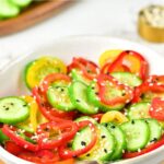 Up close view of a bowl of cucumber and bell pepper salad