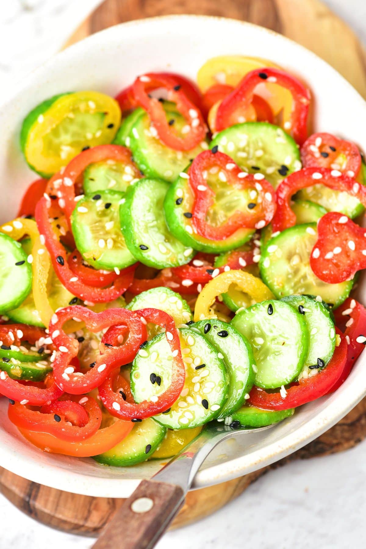Top down view of sliced cucumbers and sliced bell peppers