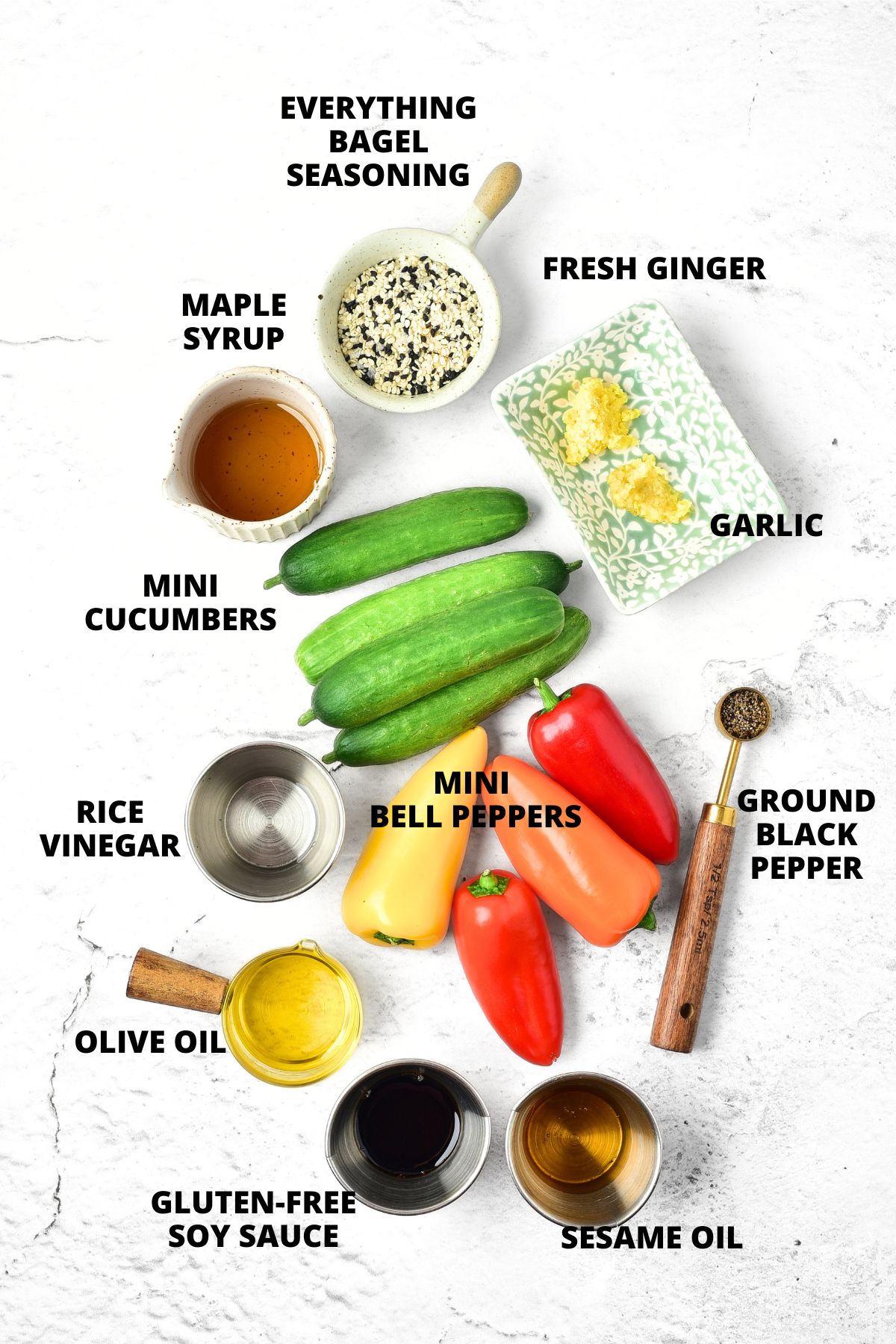 Ingredients for cucumber pepper salad recipe laid out on white board