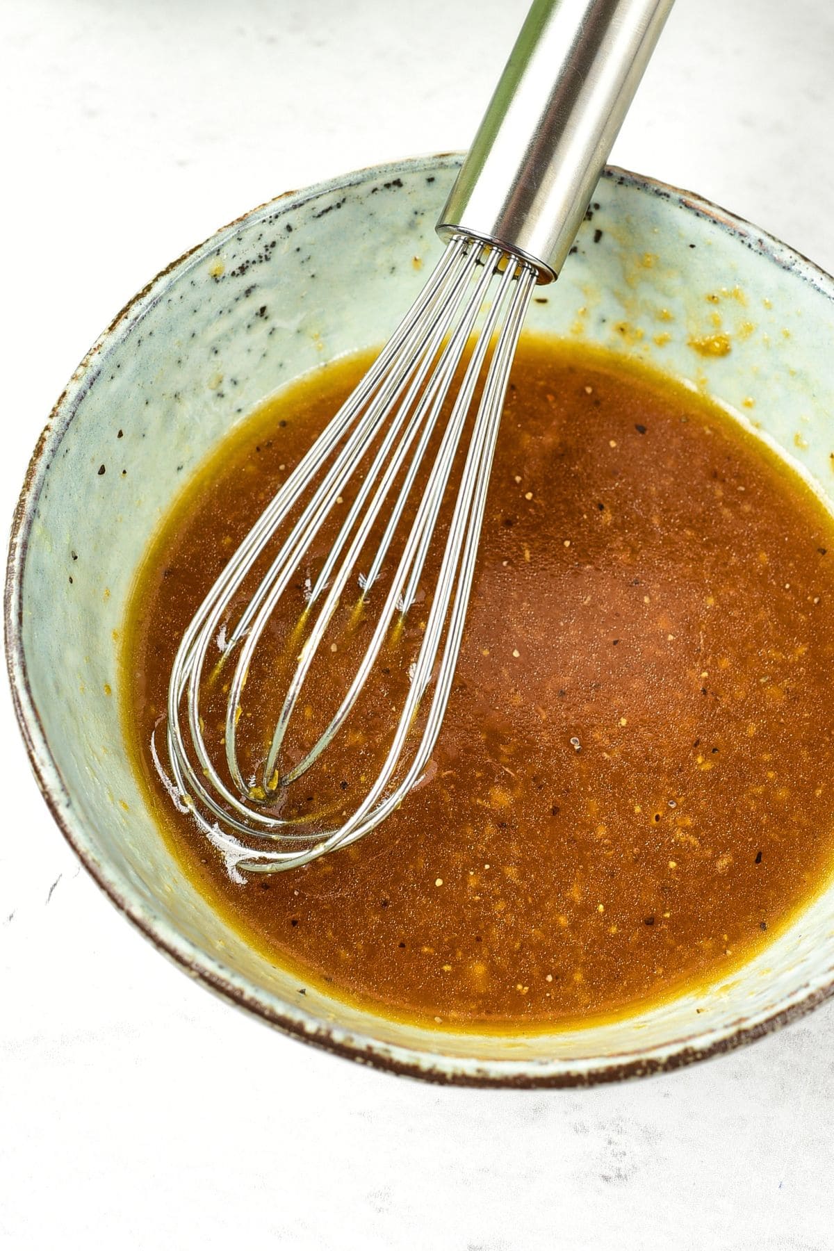 Whisking vinaigrette in bowl