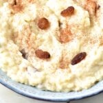 A bowl of rice pudding topped with raisins