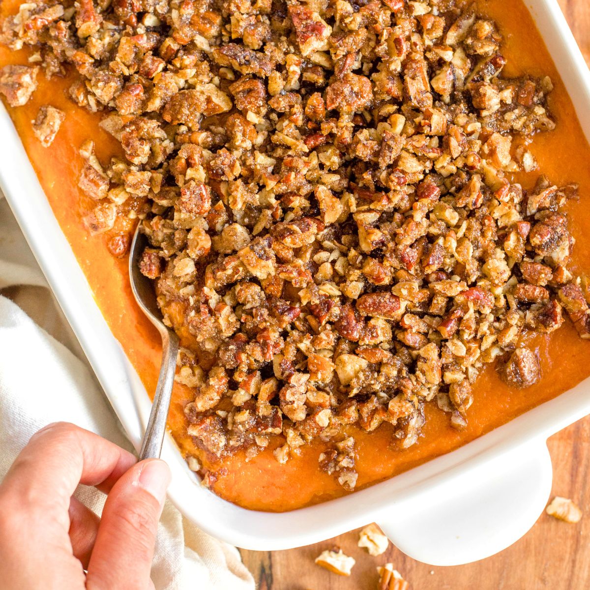 Scooping into a dairy-free sweet potato casserole