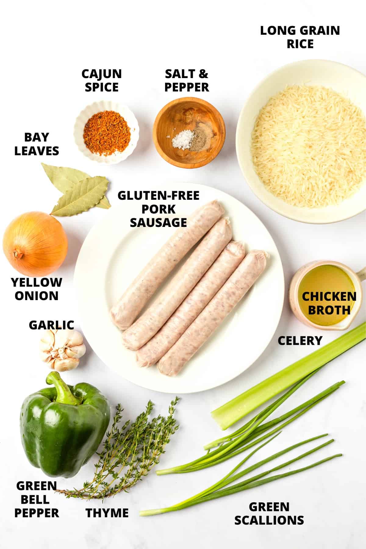 Ingredients for sausage dirty rice laid out on marble board.