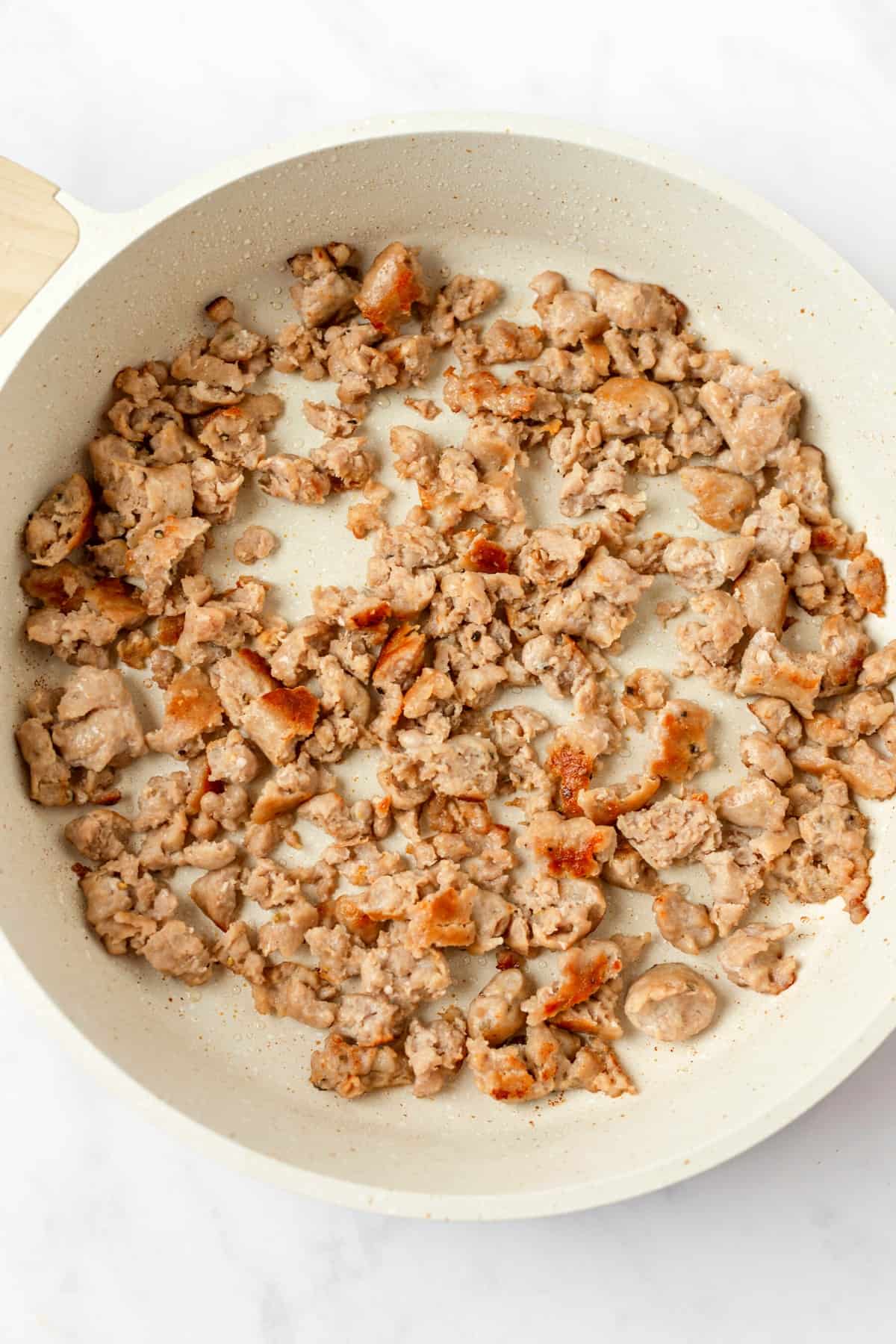 Sausage cooking in a skillet.
