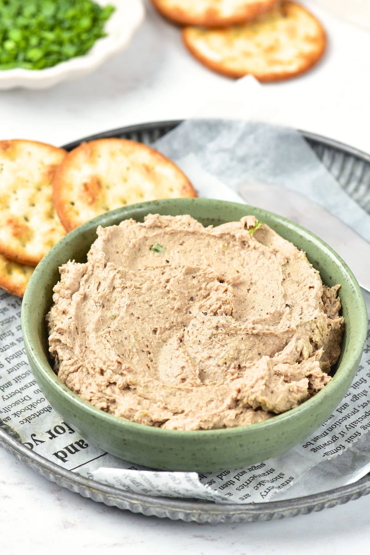 A bowl of duck liver pate on tray