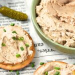 Crackers topped with pate and sprinkled with chives.