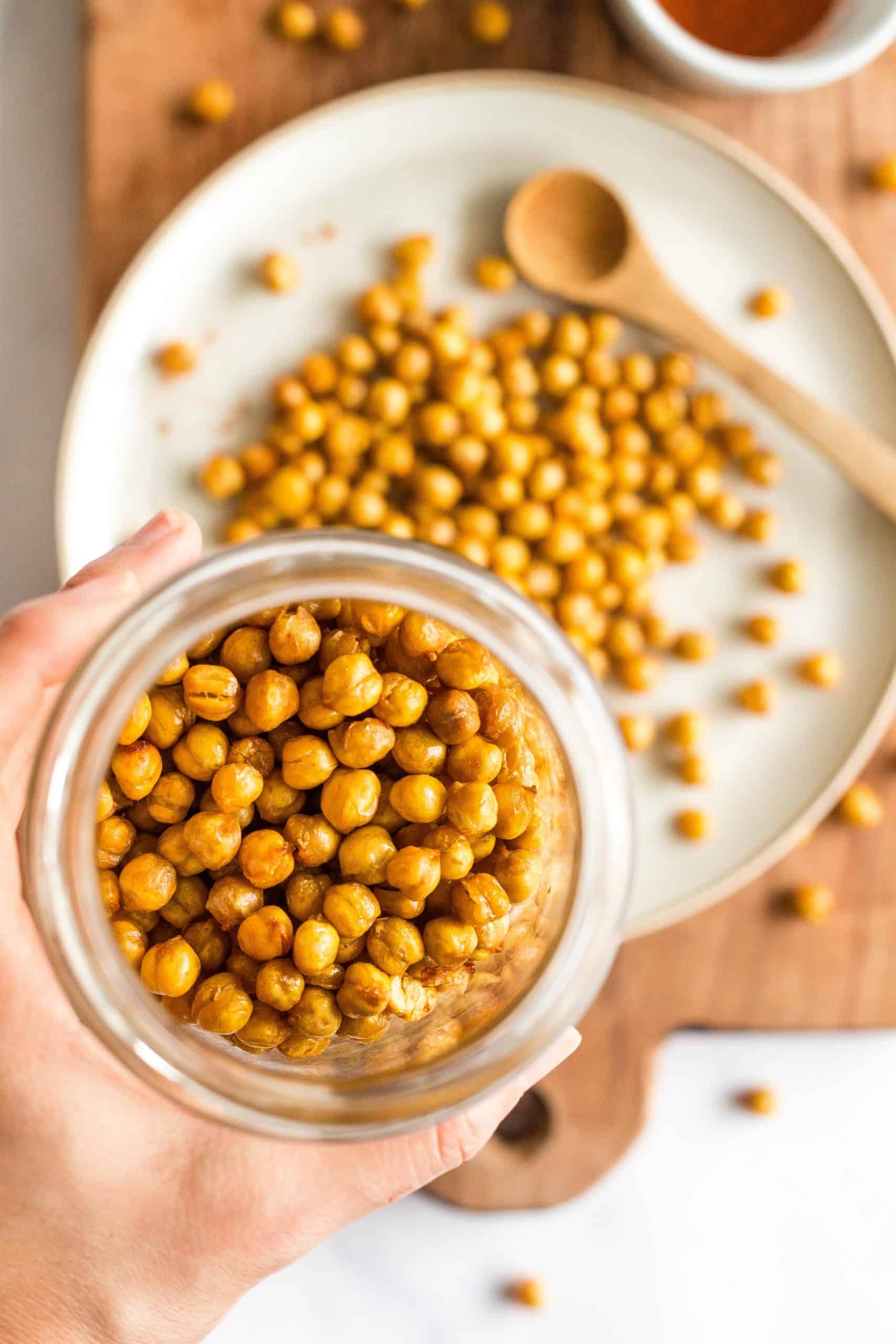 Holding up a jar of air fried chickpeas.