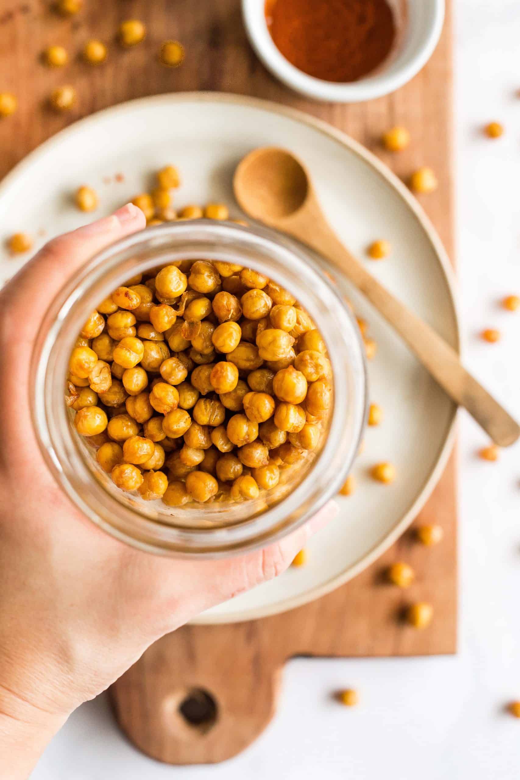 Holding up a jar of air fried chickpeas.