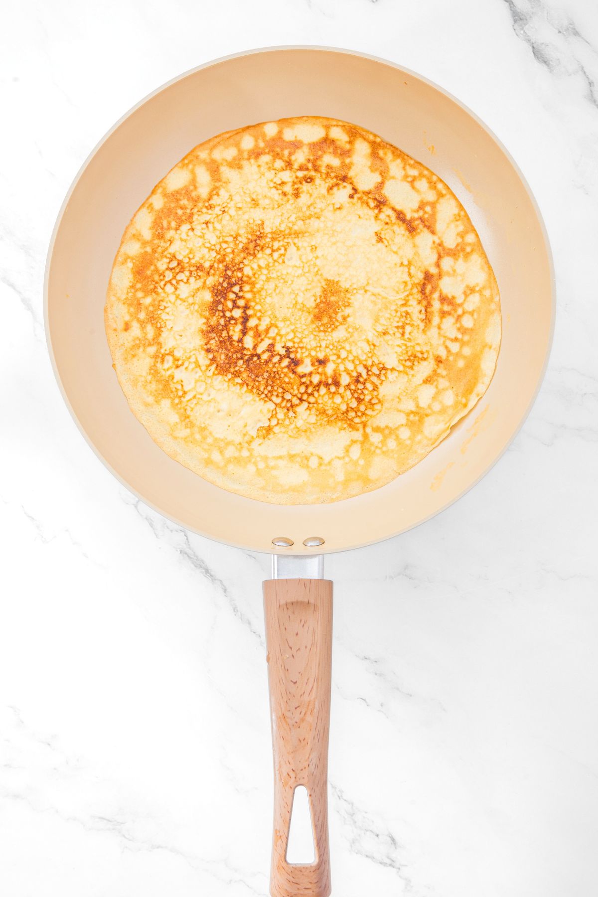Cooked almond flour crepe in skillet