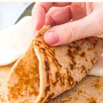 Folding an almond flour tortilla into half