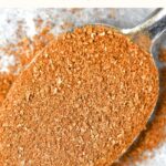 A spoonful of homemade apple pie spice on parchment.