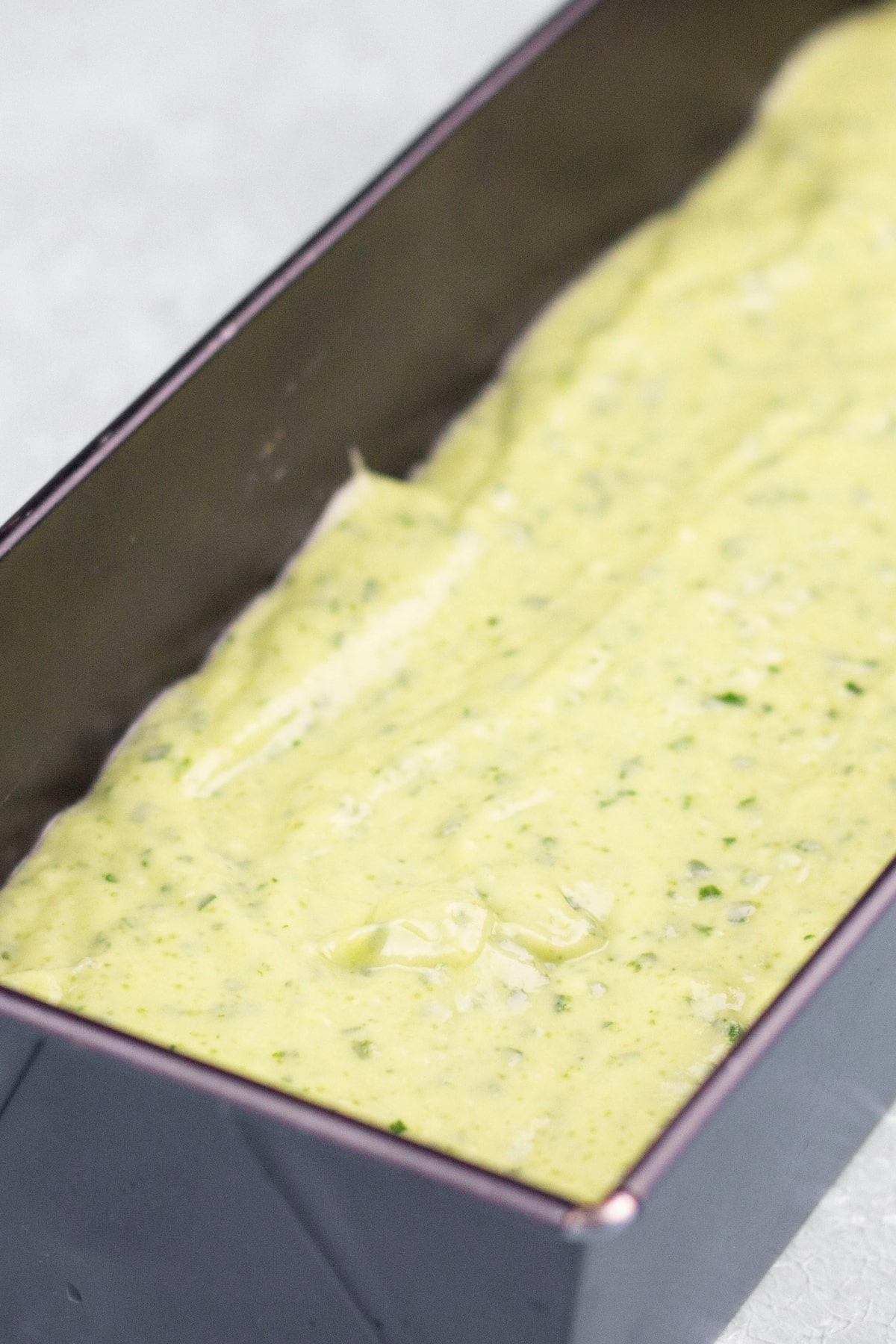 Vegan Avocado Cake (Gluten-Free) Green batter in cake pan.