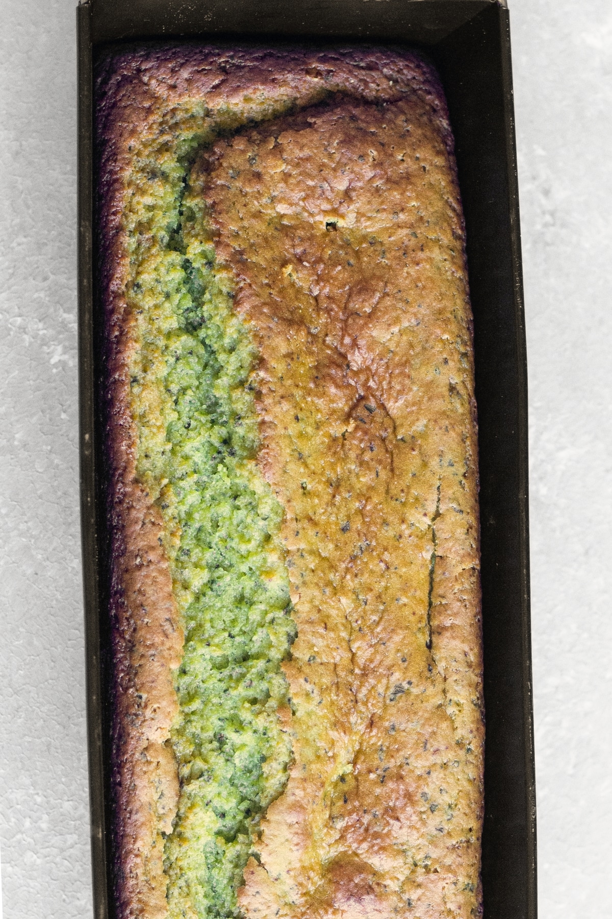 Easy Avocado Cake Recipe (Gluten-Free, Vegan) Top down view of freshly baked avocado cake in pan