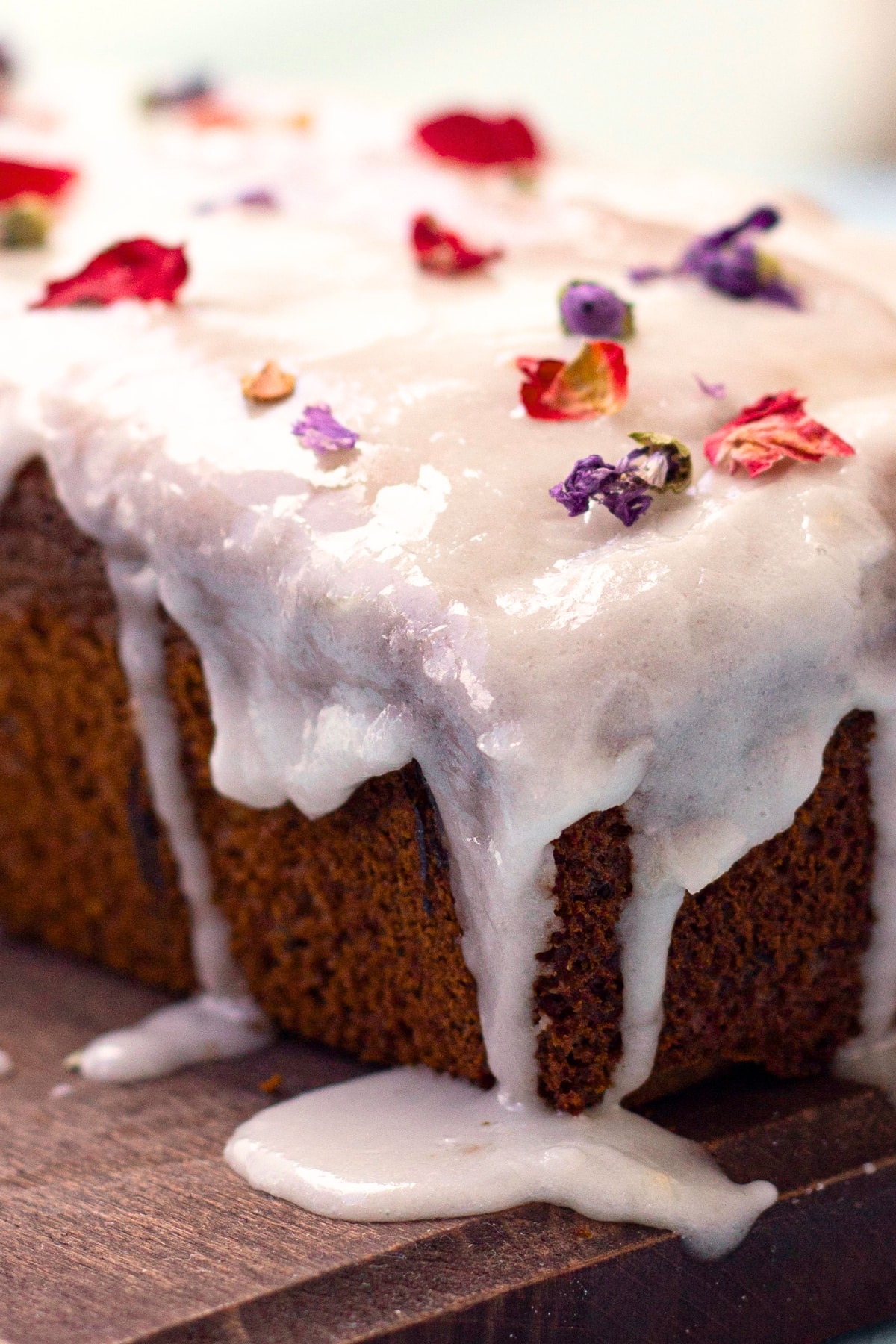 Lemon Glazed Avocado Cake Lemon glaze dripping down from avocado cake