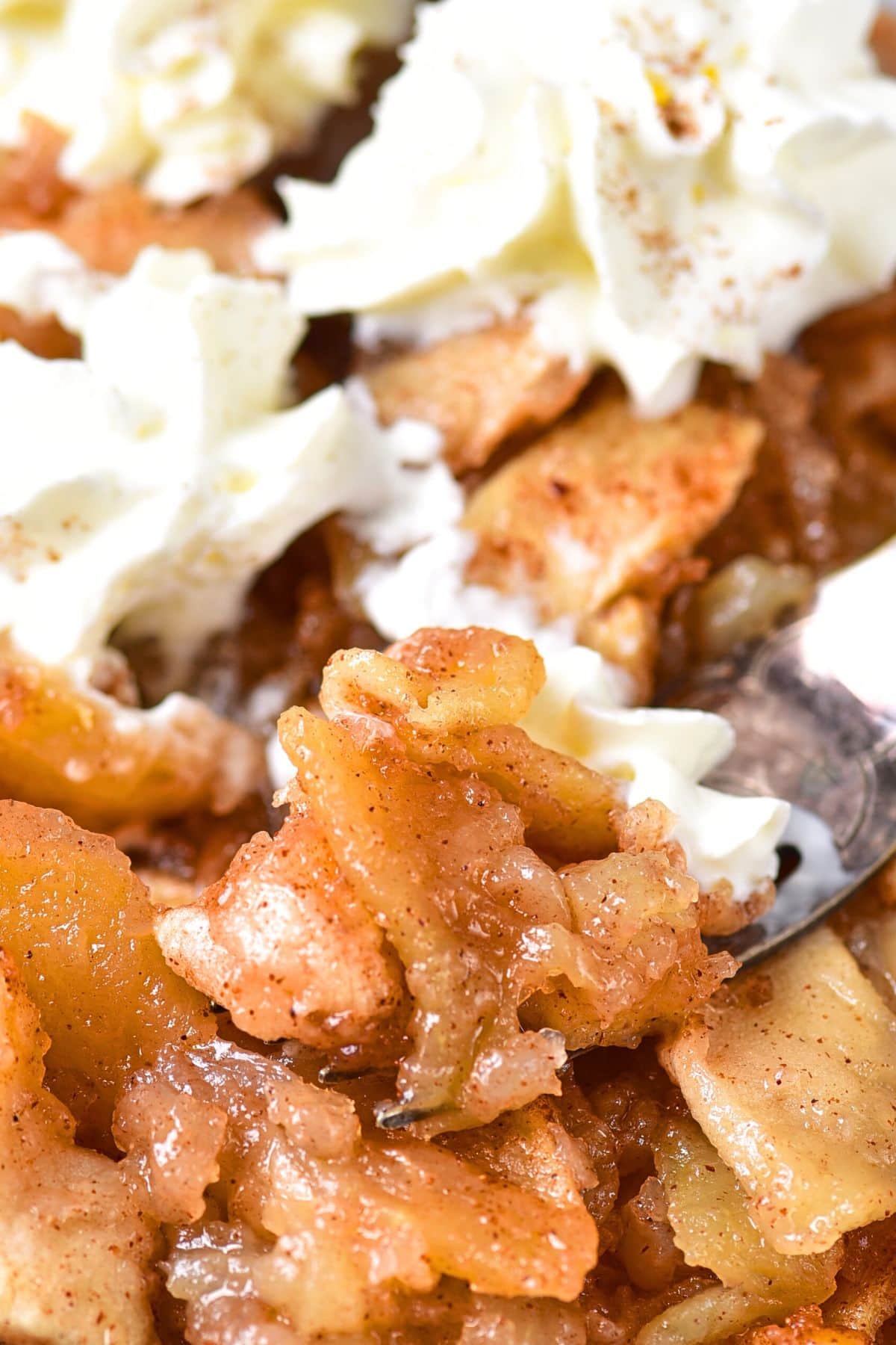 Picking up forkful of baked apple slices